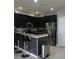 Kitchen features granite countertops, dark cabinetry, stainless steel appliances and breakfast bar at 1217 Honey Blossom Dr, Orlando, FL 32824