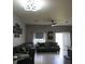 Spacious living room with tile flooring, ceiling fan and a wall of photos at 1217 Honey Blossom Dr, Orlando, FL 32824