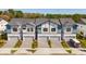 Aerial view of new townhomes with well-maintained landscaping and paved driveways at 10287 Ebb Tide Lane, Orlando, FL 32821