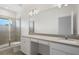 Luxurious bathroom featuring double sinks, a spacious counter, and a glass-enclosed shower at 10287 Ebb Tide Lane, Orlando, FL 32821