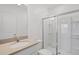 Bright bathroom with a shower stall and a vanity with light countertop, and white cabinetry at 10287 Ebb Tide Lane, Orlando, FL 32821