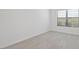 Neutral bedroom featuring tile flooring, a window, and a blank canvas for personalization at 10287 Ebb Tide Lane, Orlando, FL 32821