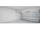 Spacious two-car garage with block walls and an automatic door at 10287 Ebb Tide Lane, Orlando, FL 32821