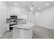 Bright kitchen boasts white cabinetry, stainless steel appliances, and pendant lighting at 10287 Ebb Tide Lane, Orlando, FL 32821