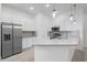 Eat-in kitchen featuring stainless steel refrigerator, granite countertop, and stainless steel appliances at 10287 Ebb Tide Lane, Orlando, FL 32821