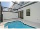 Screened-in pool area with an in-ground pool and view of the home's exterior at 10287 Ebb Tide Lane, Orlando, FL 32821
