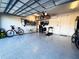 Organized two-car garage featuring epoxy flooring, ample storage and bikes at 10394 Spring Arbor Ln, Winter Garden, FL 34787