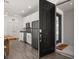 Welcoming entryway flows into kitchen, featuring black appliances, granite countertops, and white cabinets at 11354 History Ave, Orlando, FL 32832