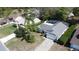 An aerial shot shows a well-maintained home featuring a screened-in pool and lush landscaping at 129 Pine Lake View Dr, Davenport, FL 33837