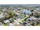 Aerial view showcasing a residential area near a lake, homes with pools, offering a picturesque living environment at 129 Pine Lake View Dr, Davenport, FL 33837