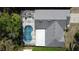 Bird's eye view of a home highlighting its screened pool area and manicured surroundings at 129 Pine Lake View Dr, Davenport, FL 33837