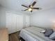 Bedroom with wooden floors, ceiling fan, and ample closet space at 129 Pine Lake View Dr, Davenport, FL 33837