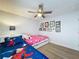 Shared bedroom boasts twin beds, playful decor, and ceiling fan at 129 Pine Lake View Dr, Davenport, FL 33837