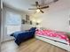 Shared bedroom featuring ceiling fan, natural light, and two twin beds at 129 Pine Lake View Dr, Davenport, FL 33837
