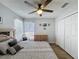 Comfortable bedroom featuring a ceiling fan, ample closet space, and natural light at 129 Pine Lake View Dr, Davenport, FL 33837