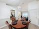 Inviting dining area with wood floors, stylish chandelier, and seating for four at 129 Pine Lake View Dr, Davenport, FL 33837