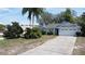 Inviting single-story home with a well-maintained lawn and spacious driveway, perfect for Gathering living at 129 Pine Lake View Dr, Davenport, FL 33837
