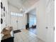 Inviting foyer with tile flooring, a modern chandelier, and views into the living area at 129 Pine Lake View Dr, Davenport, FL 33837