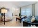 Comfortable living room with a large window, stylish furniture, and neutral tones at 129 Pine Lake View Dr, Davenport, FL 33837