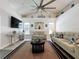 Spacious living room with vaulted ceilings, a ceiling fan, and a stylish entertainment center at 129 Pine Lake View Dr, Davenport, FL 33837