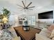 Open-concept living space with seamless kitchen view and access to the pool area at 129 Pine Lake View Dr, Davenport, FL 33837