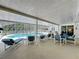 Screened-in patio area with outdoor seating, lounge chairs, and view of the private pool at 129 Pine Lake View Dr, Davenport, FL 33837