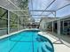A refreshing pool with a screened enclosure, tanning deck, and lounge area perfect for relaxation and entertaining at 129 Pine Lake View Dr, Davenport, FL 33837