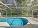 A beautiful enclosed pool with clear blue water and a clean, well-maintained pool deck for relaxing or entertaining at 129 Pine Lake View Dr, Davenport, FL 33837