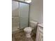 Compact bathroom features a stand-up shower, toilet, and a small vanity at 132 Santana Pl, Davenport, FL 33897