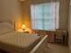 Comfortable bedroom with a soft mattress, wooden furnishings and sun-filled window at 132 Santana Pl, Davenport, FL 33897