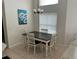 Cozy dining area featuring a dark wood table, decorative light fixture, and natural light at 132 Santana Pl, Davenport, FL 33897