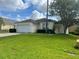 Charming single-story home featuring a well-maintained lawn and an attached two-car garage at 132 Santana Pl, Davenport, FL 33897