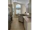 Bright kitchen featuring white cabinets, stainless steel appliances, and a cozy dining area with natural light at 132 Santana Pl, Davenport, FL 33897