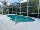 Private screened-in pool offers a refreshing escape with ample space for relaxation and leisure at 132 Santana Pl, Davenport, FL 33897