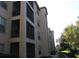 Exterior of the building shows balconies and lush landscaping at 1361 Tuscan Ter # 7406, Davenport, FL 33896