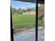View from sliding glass doors of the grassy backyard and stairs to an upper level at 145 Scottsdale Sq # 145, Winter Park, FL 32792