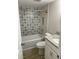 Bathroom featuring patterned tiles, white cabinets, and granite counters at 145 Scottsdale Sq # 145, Winter Park, FL 32792