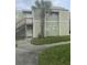 Charming two-story home with a well-maintained lawn and walkway to front door at 145 Scottsdale Sq # 145, Winter Park, FL 32792