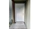 A close-up of the white front door with the number 145 above the doorway and a small ramp for accessibility at 145 Scottsdale Sq # 145, Winter Park, FL 32792