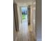 Bright hallway with wood-look flooring leading to the entrance and offering closet space at 145 Scottsdale Sq # 145, Winter Park, FL 32792