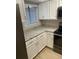 This is a bright kitchen featuring granite countertops, white cabinets, and stainless steel appliances at 145 Scottsdale Sq # 145, Winter Park, FL 32792