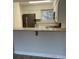 This is a kitchen bar that features stainless appliances and an open living space concept at 145 Scottsdale Sq # 145, Winter Park, FL 32792