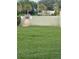 Community pool area with closed gate and lush green grass, ensuring a private and serene swimming experience at 145 Scottsdale Sq # 145, Winter Park, FL 32792