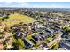 Aerial view of a residential neighborhood showcasing well-maintained homes and green spaces on a sunny day at 16014 Hawk Hill St, Clermont, FL 34714