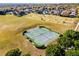 Aerial view of the community tennis court and common areas near a neighborhood at 16014 Hawk Hill St, Clermont, FL 34714