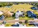 Aerial view of neighborhood homes with lush landscaping and community tennis court at 16014 Hawk Hill St, Clermont, FL 34714