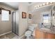 Bathroom with granite countertops, large mirror, tiled floors, a shower, and a toilet at 16014 Hawk Hill St, Clermont, FL 34714