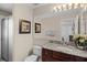 Bathroom featuring granite countertops, a large mirror, a walk-in shower, and a toilet at 16014 Hawk Hill St, Clermont, FL 34714