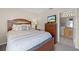 A well-decorated bedroom featuring wooden furniture, comfortable bedding, and a television for entertainment at 16014 Hawk Hill St, Clermont, FL 34714