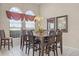 Formal dining room with a large table, chandelier, and natural light from windows at 16014 Hawk Hill St, Clermont, FL 34714
